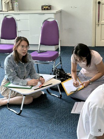 Participants taking notes during pair practice