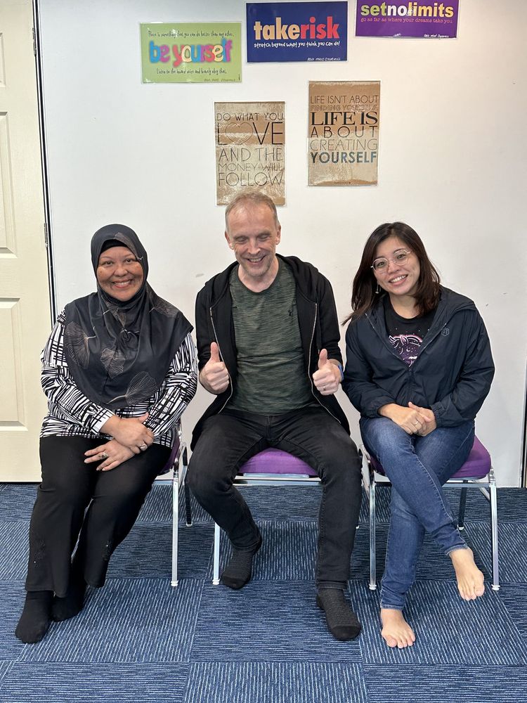 Andreas and Najwa with a training graduate